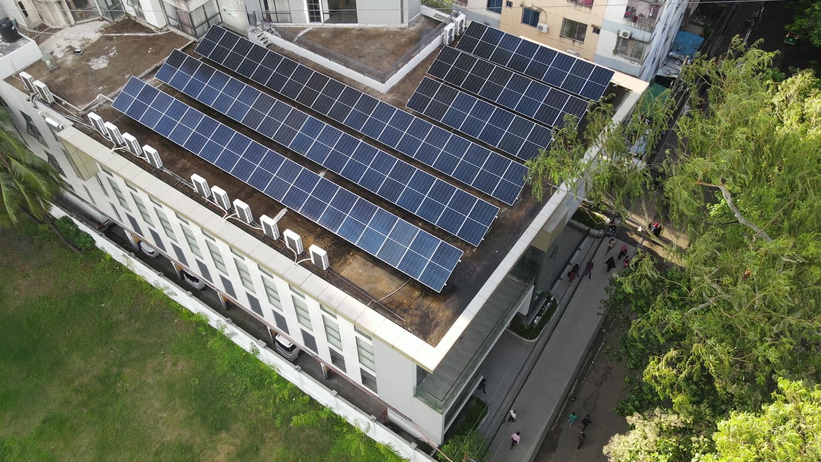 Aerial view of a large rooftop solar array installed across the roof of a building